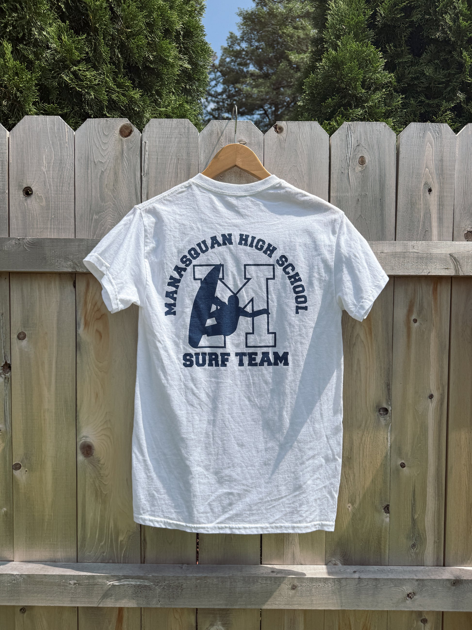 Manasquan High School Surf team classic unisex tee featuring a front logo hit and full back graphic. Soft, comfortable, and made for life on and off the beach. 100% Cotton